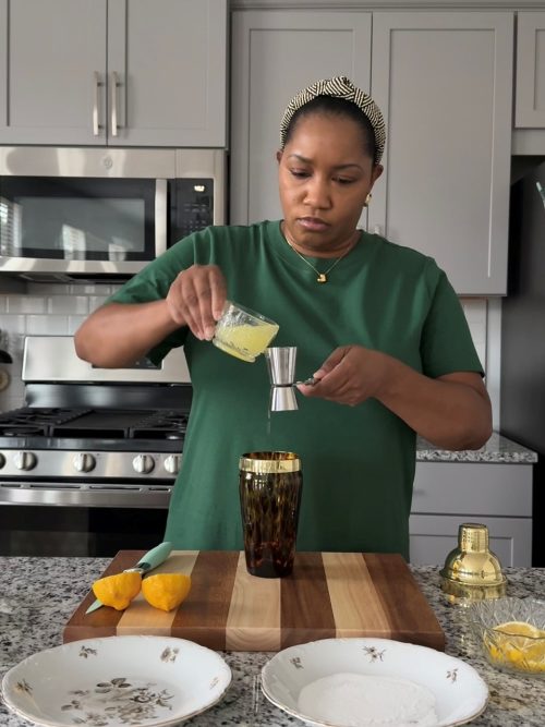 Adding fresh lemon juice to cocktail shaker.