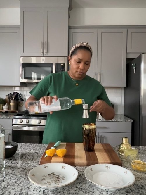 Adding vodka to a cocktail shaker.